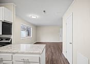 Thumbnail 5 of 20 - A kitchen with a marble countertop and white cabinets.