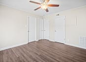 Thumbnail 8 of 20 - A room with a ceiling fan and three doors.