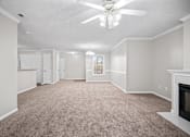 Thumbnail 7 of 22 - A room with a carpet floor and a ceiling fan.