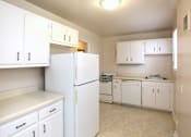 Thumbnail 5 of 14 - View of kitchen model with white cabinets, refrigerator, dishwasher, range