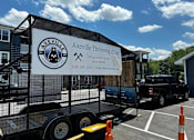 Thumbnail 43 of 45 - a trailer with a sign on it in a parking lot