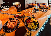 Thumbnail 38 of 45 - a buffet table with food on it in a room with televisions