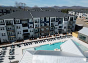 Thumbnail 39 of 45 - an aerial view of an apartment building with a swimming pool