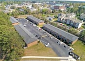 Thumbnail 6 of 13 - A parking lot is in front of a building.