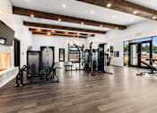 Thumbnail 8 of 19 - A gym with a variety of equipment including treadmills, weights, and exercise machines.