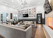 Thumbnail 7 of 19 - A modern living room with a grey sofa set and a chandelier.