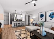 Thumbnail 12 of 19 - A modern living room with a white sofa, a coffee table, and a ceiling fan.