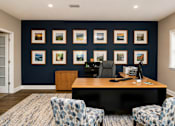 Thumbnail 21 of 21 - A room with a desk, chairs and pictures on the wall.