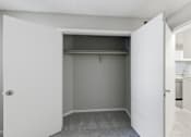 Thumbnail 13 of 29 - A white closet with a shelf and a grey carpet.