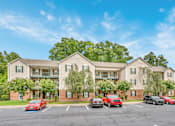 Thumbnail 22 of 22 - A large building with a parking lot in front of it.