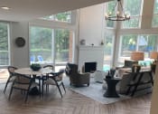 Thumbnail 24 of 36 - Leasing Office with view of fireplace, seating and pool visible through windows  at Huntington Apartments, North Carolina, 27560