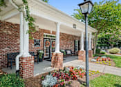 Thumbnail 43 of 46 - A building with a white roof and pillars with a sign that says 245.