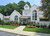 Thumbnail 18 of 36 - Driveway view of leasing office and Clubhouse  at Huntington Apartments, Morrisville, NC
