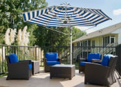 Thumbnail 28 of 36 - Sundeck with chairs and umbrellas  at Huntington Apartments, North Carolina, 27560