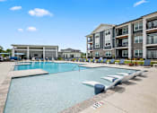Thumbnail 1 of 31 - A swimming pool with a building in the background.