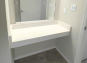 Thumbnail 11 of 36 - Vanity with mirror and lighting  at Huntington Apartments, Morrisville, 27560