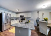 Thumbnail 2 of 20 - Kitchen with Island/Bar, Stainless Steel Appliance Package, Granite Countertops and round Dining Room Table with 4 chairs