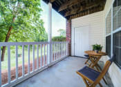 Thumbnail 18 of 20 - Covered Patio with 2 chairs and a table and a view of trees