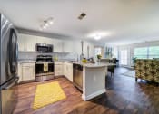 Thumbnail 1 of 20 - Open Floor Plan showing Kitchen with Bar, Dining Area, and Living Room