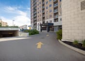 Thumbnail 14 of 21 - an empty parking lot in front of an apartment building with an arrow painted on it