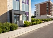 Thumbnail 18 of 21 - a modern building with a sidewalk in front of it