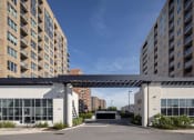 Thumbnail 15 of 21 - awning over a parking lot between two apartment buildings