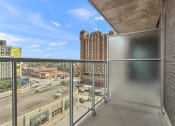 Thumbnail 41 of 59 - a balcony with a view of a city street and a glass railing