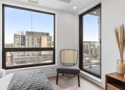 Thumbnail 39 of 59 - a bedroom with a large window and a city view