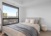 Thumbnail 36 of 59 - a bedroom with a bed and a large window