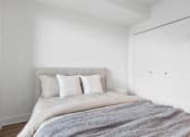 Thumbnail 44 of 59 - a bedroom with a bed and a white wardrobe