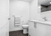 Thumbnail 48 of 59 - a white bathroom with a toilet and a sink