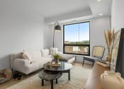 Thumbnail 31 of 59 - a living room with a white couch and a large window