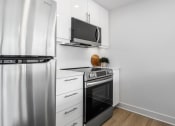 Thumbnail 28 of 59 - a kitchen with stainless steel appliances and a refrigerator