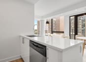 Thumbnail 25 of 59 - a kitchen with a large counter top and a sink