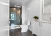 Thumbnail 20 of 59 - a white bathroom with a toilet and a shower