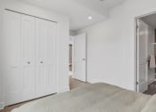 Thumbnail 15 of 59 - a bedroom with white closets and a large bed