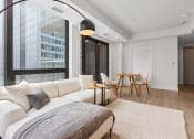 Thumbnail 21 of 59 - a living room with a white couch and a large window