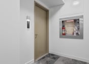 Thumbnail 12 of 59 - a door in a white room with a poster on the wall