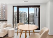 Thumbnail 10 of 59 - a dining room with a table and chairs in front of a window