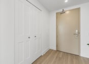 Thumbnail 26 of 59 - a room with white closets and a sliding door