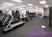 Thumbnail 2 of 59 - a gym with cardio equipment and yoga mats