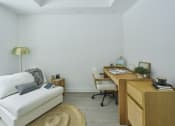 Thumbnail 35 of 46 - a living room with a couch and a desk
