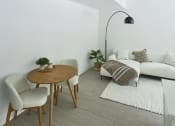 Thumbnail 41 of 46 - a living room with a white couch and a wooden table