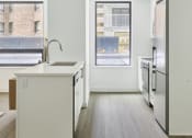 Thumbnail 40 of 46 - an empty kitchen with a large window and a sink and a refrigerator