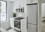 Thumbnail 26 of 46 - a kitchen with white cabinets and stainless steel appliances