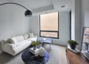 Thumbnail 15 of 46 - a living room with a white couch and a blue table