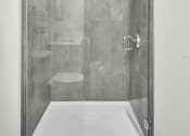 Thumbnail 10 of 46 - a shower with a glass door in a bathroom