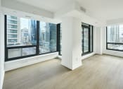 Thumbnail 28 of 46 - an empty living room with large windows and wood floors