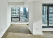 Thumbnail 12 of 46 - a living room with a large window and a view of the city