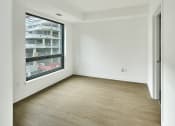 Thumbnail 32 of 46 - an empty room with white walls and a large window